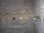 Postholes in adobe wall