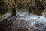 A typical dwelling, complete with alcoves, central fire pit, and soot-covered walls